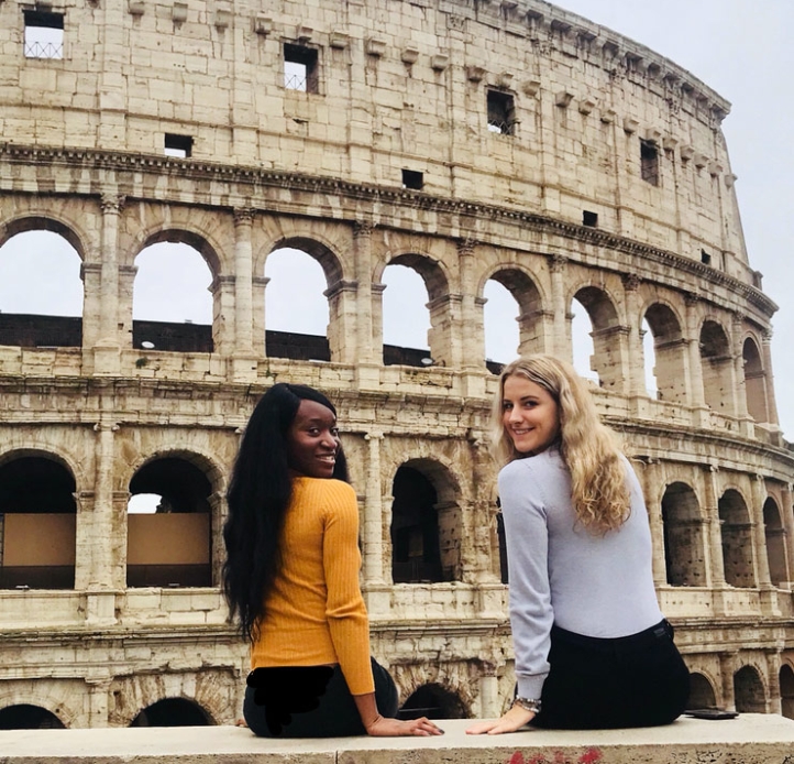 Two students sitting near the Coliseum