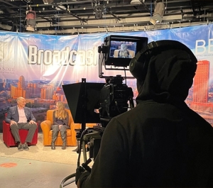 Student filming on a TV set